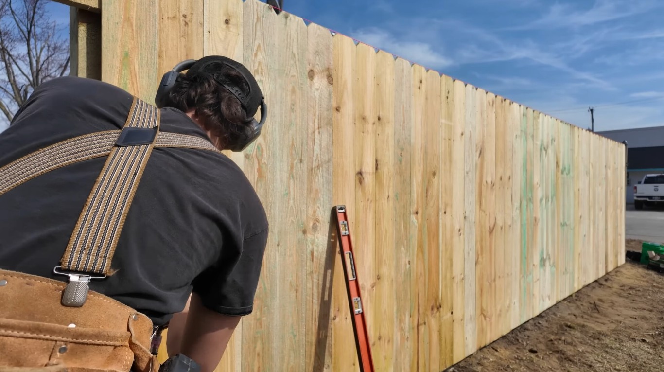 Professional fence contractor installing wood fence in Santa Cruz, CA